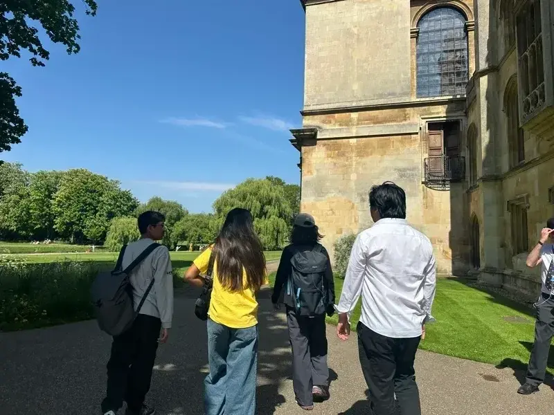 Students walking through a historic university campus